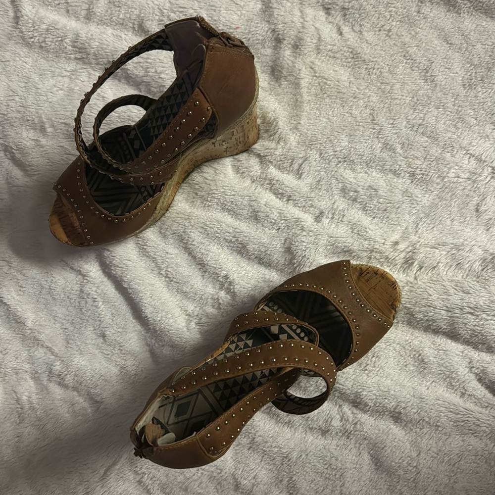 High wedged shoes. Tan with hems and cross strapped.